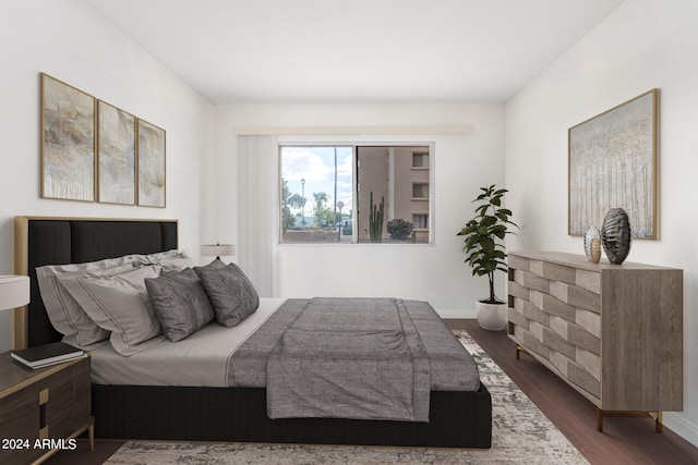 bedroom with dark hardwood / wood-style floors