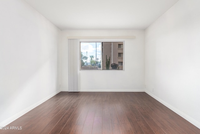 empty room featuring dark wood-type flooring