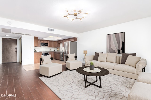 living room featuring a chandelier, dark wood-type flooring, and sink