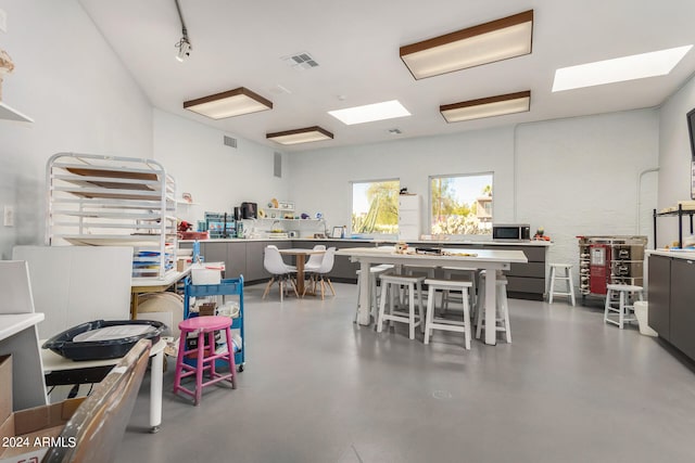 misc room with concrete floors and track lighting