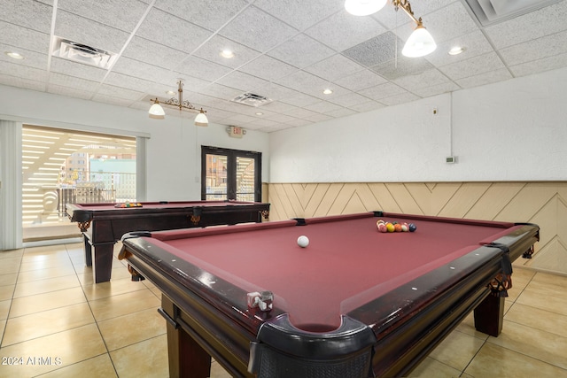 playroom featuring light tile patterned floors, wooden walls, a paneled ceiling, and pool table