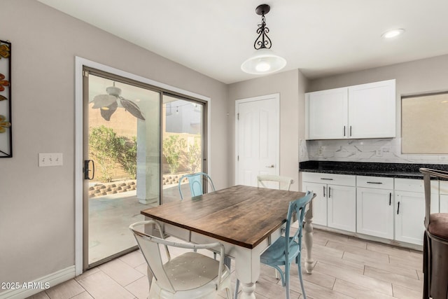 dining space featuring baseboards and light wood-type flooring