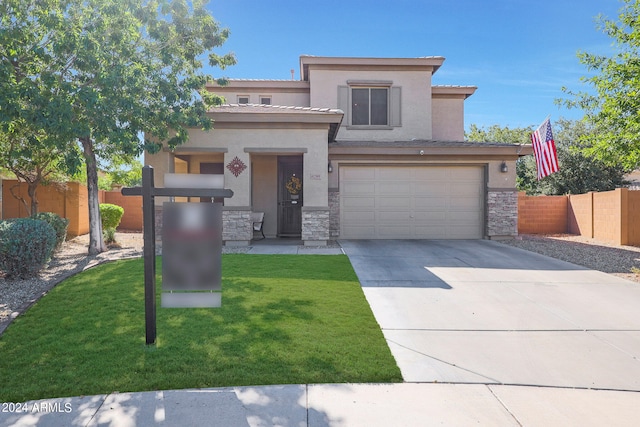 view of front of home with a front yard and a garage