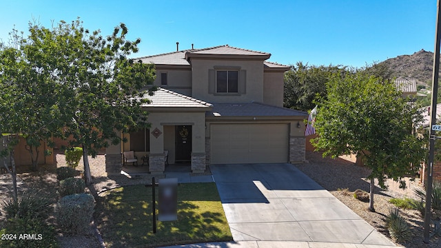 view of front of property with a front yard and a garage