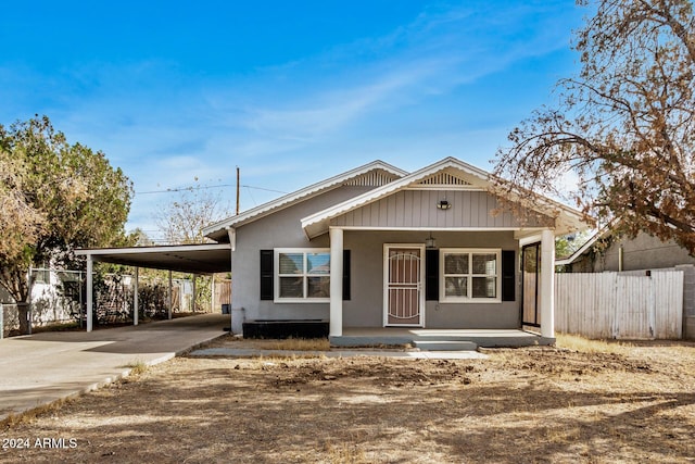 view of front of house featuring a carport and covered porch