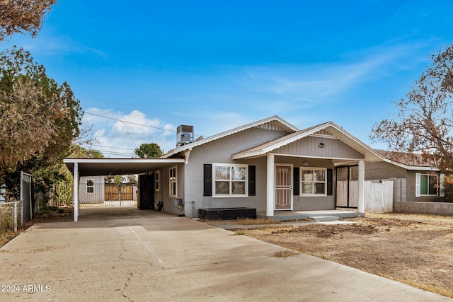 view of front of property featuring a carport and a porch