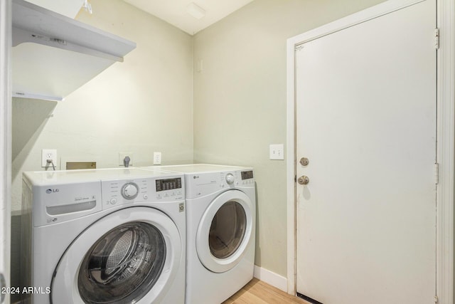 laundry area featuring light wood-type flooring and washing machine and clothes dryer