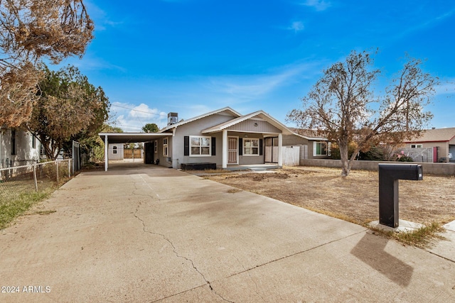 view of front of property featuring covered porch and a carport