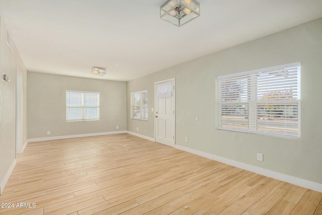 spare room featuring light hardwood / wood-style flooring