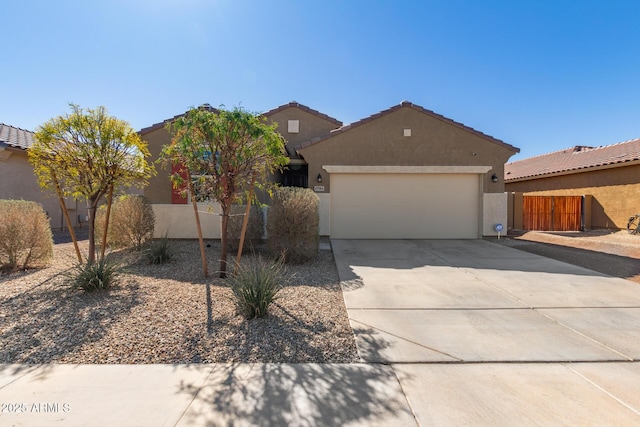 view of front of property with driveway, an attached garage, a tile roof, and stucco siding