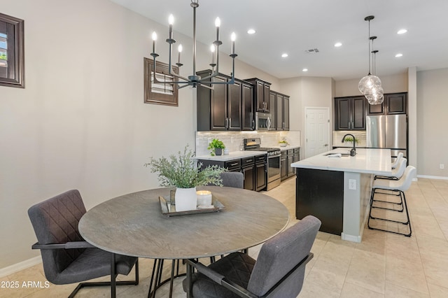 dining area featuring recessed lighting, baseboards, light tile patterned floors, and a chandelier