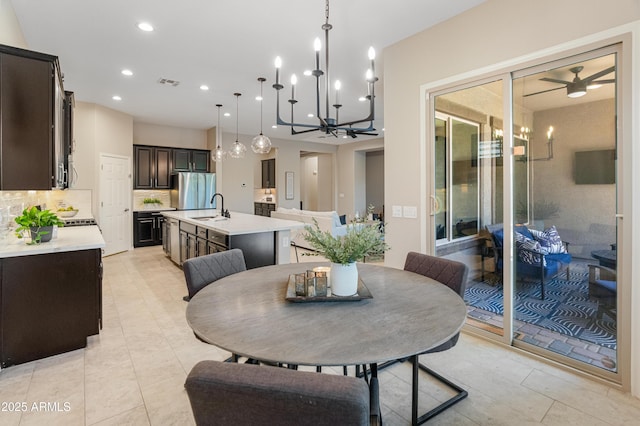 dining room featuring a ceiling fan, a chandelier, recessed lighting, and light tile patterned floors