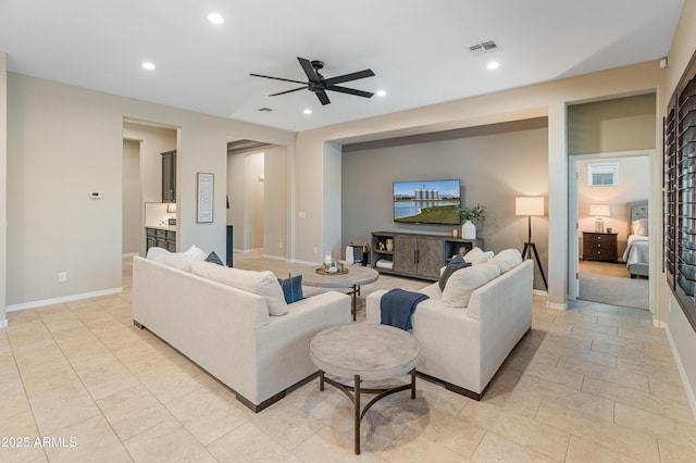 living area with ceiling fan, recessed lighting, and baseboards