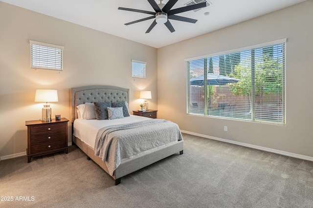 carpeted bedroom featuring baseboards and a ceiling fan