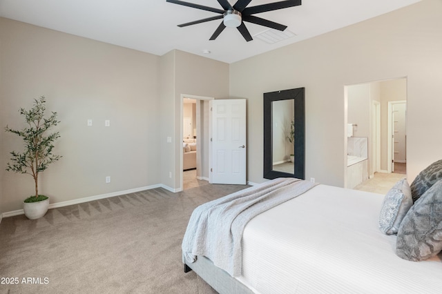 bedroom with light carpet, baseboards, ensuite bathroom, and a ceiling fan