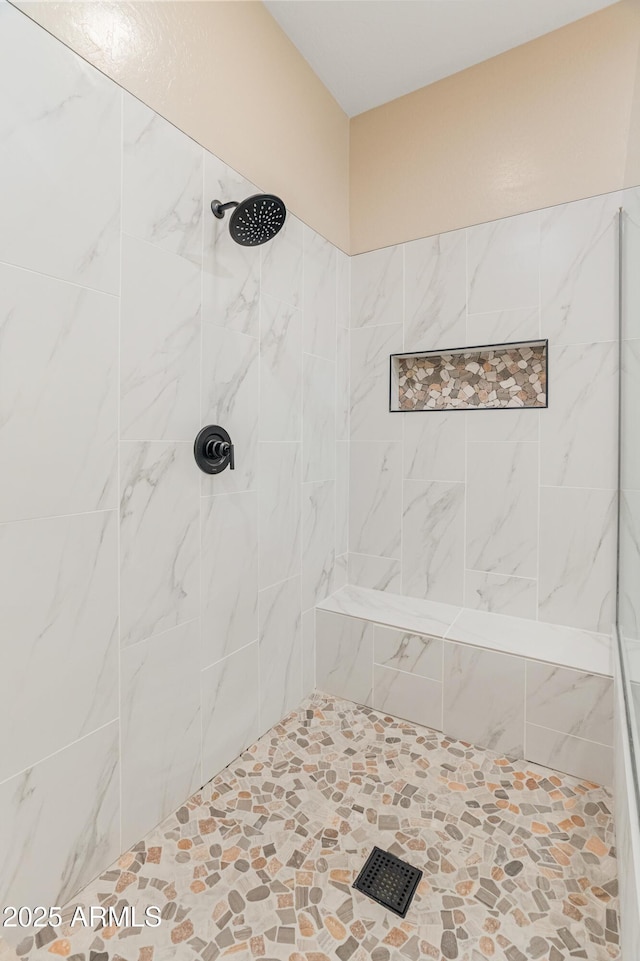 full bath featuring a tile shower