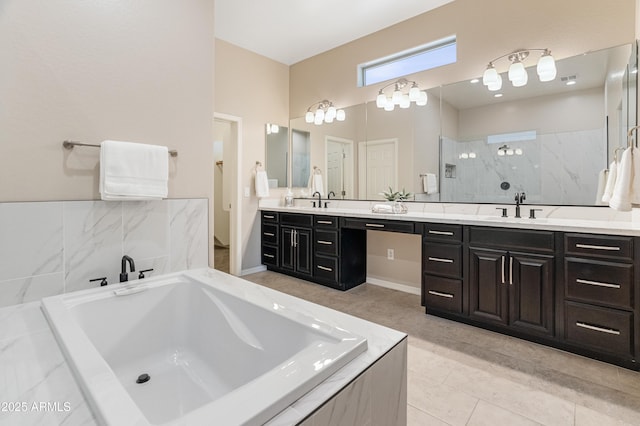 bathroom with a bath, vanity, a walk in shower, and tile patterned floors