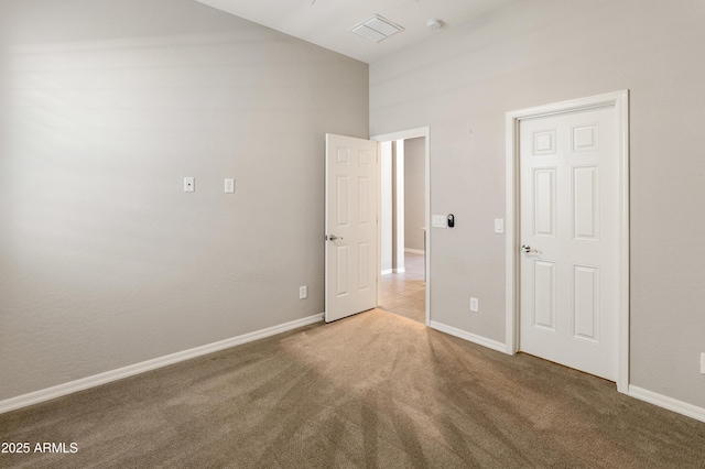 unfurnished bedroom with carpet floors and baseboards