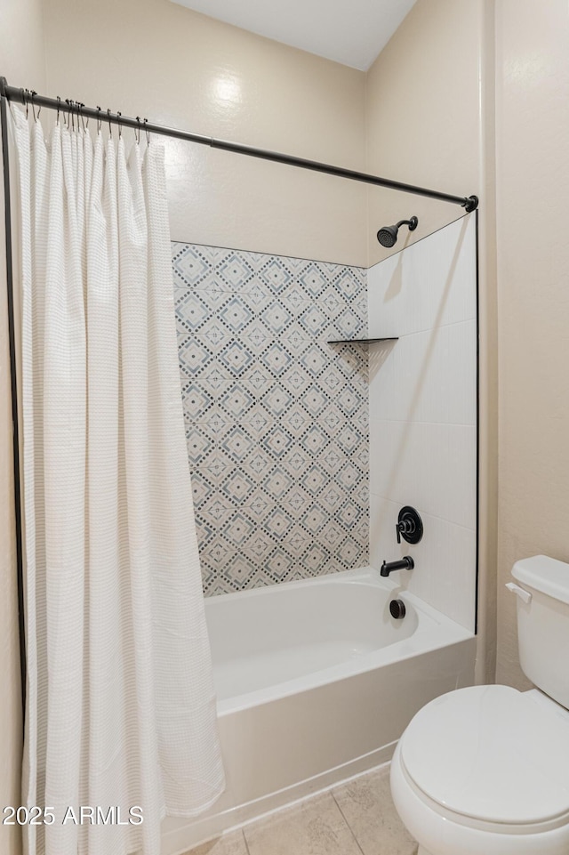 full bath featuring shower / bath combo with shower curtain, toilet, and tile patterned flooring