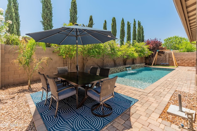 view of pool with a fenced backyard, a patio area, and outdoor dining space