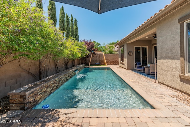 view of pool with a fenced backyard and a patio