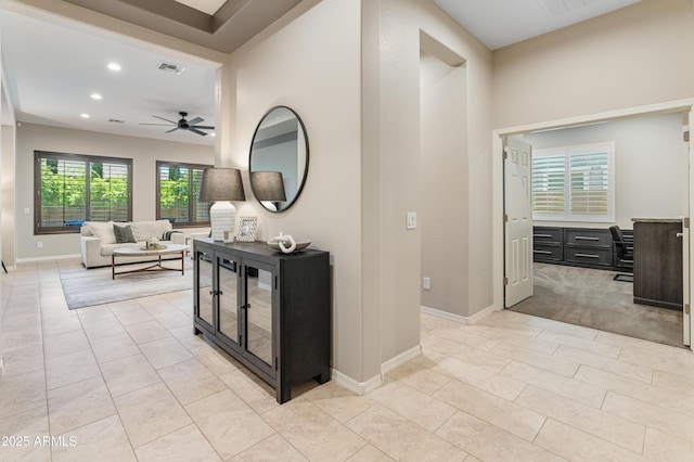 hall with recessed lighting, light tile patterned flooring, and baseboards