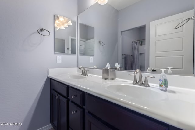 bathroom featuring dual sinks and vanity with extensive cabinet space