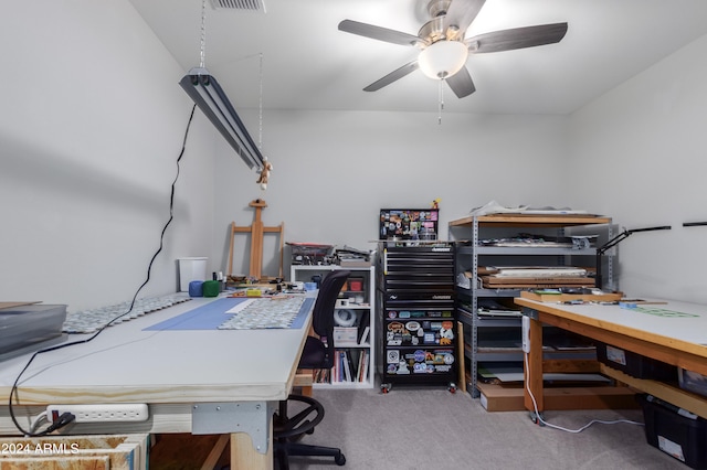 carpeted office space featuring ceiling fan