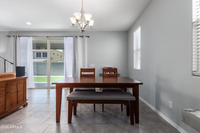 dining space featuring a chandelier and tile flooring