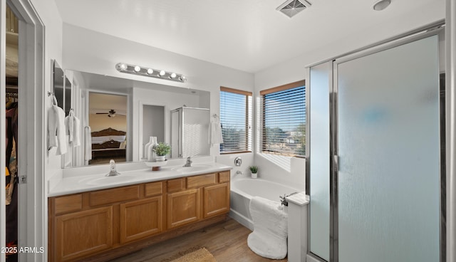 full bathroom with a sink, visible vents, a bath, double vanity, and a stall shower