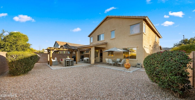 back of property featuring stucco siding, a patio, a fenced backyard, and a pergola