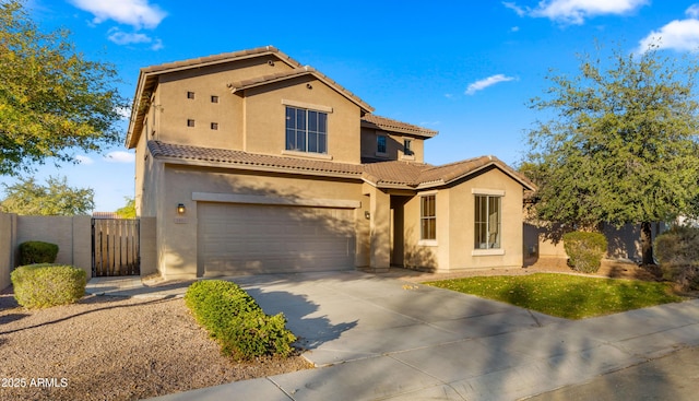 mediterranean / spanish home with an attached garage, fence, a tile roof, driveway, and stucco siding