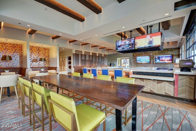 dining area featuring beamed ceiling and recessed lighting