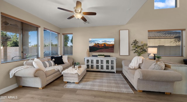 living area with a ceiling fan, baseboards, visible vents, and wood finished floors