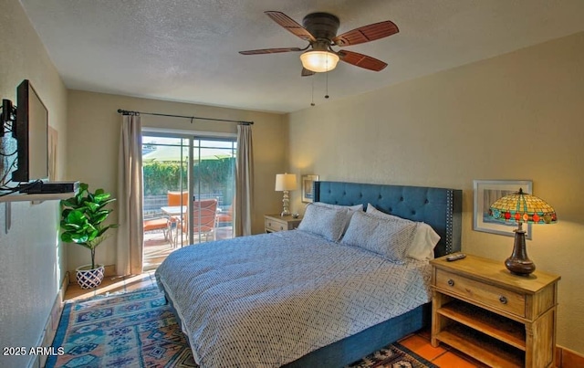 bedroom with a textured ceiling, a ceiling fan, and access to outside