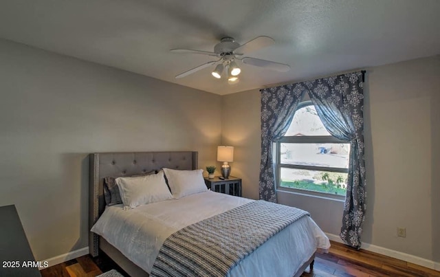 bedroom with wood finished floors, baseboards, and ceiling fan