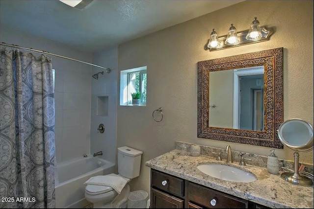 full bathroom featuring vanity, toilet, shower / bathtub combination with curtain, and a textured wall