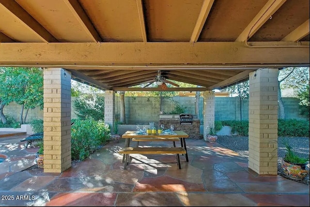 view of patio featuring a gazebo, outdoor dining area, and fence