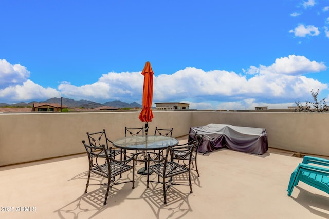 view of patio with a mountain view and area for grilling