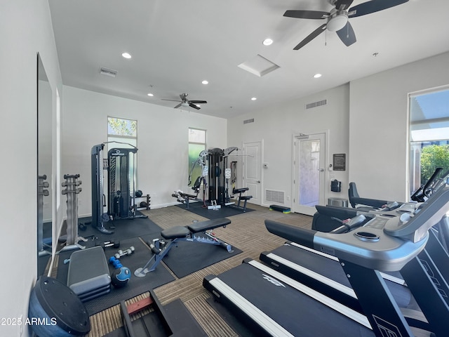 exercise room featuring dark colored carpet and ceiling fan