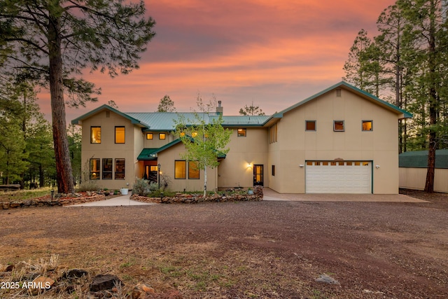 5240 Sierra Vis, Flagstaff, AZ 86001 - view of front of property featuring driveway, a garage, metal roof, and stucco siding
