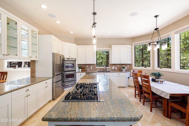 5240 Sierra Vis, Flagstaff, AZ 86001 - kitchen featuring appliances with stainless steel finishes, a center island, tasteful backsplash, white cabinets, and recessed lighting