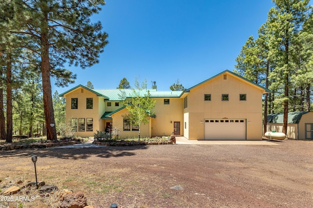 5240 Sierra Vis, Flagstaff, AZ 86001 - view of front of house with driveway, metal roof, stucco siding, a garage, and a chimney