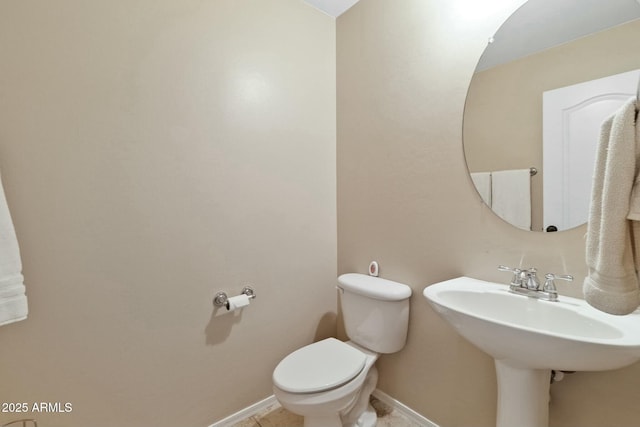 bathroom featuring tile patterned flooring, sink, and toilet