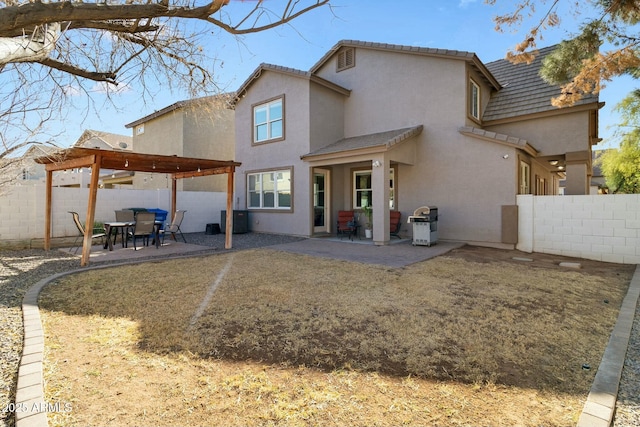 rear view of house featuring cooling unit, a pergola, and a patio area