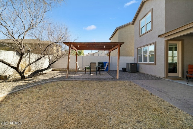 view of yard featuring a patio, central AC, and a pergola