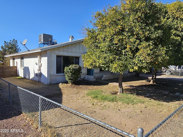 view of side of home featuring central AC