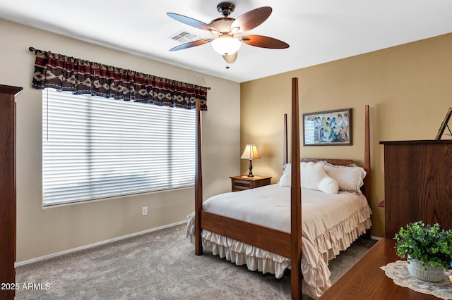 carpeted bedroom with visible vents, baseboards, and a ceiling fan