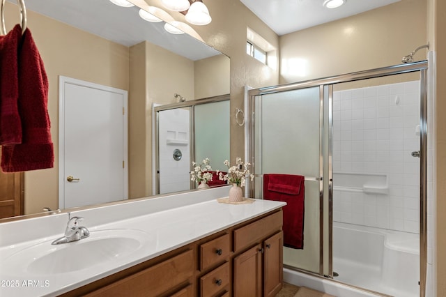 full bathroom with a shower stall and vanity