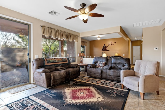 tiled living room with a ceiling fan and visible vents